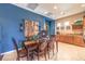 A lovely dining room is shown with a dark wood table, six chairs and a beige tiled floor at 2375 Malaga Peak St, Las Vegas, NV 89135