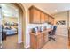 Upstairs landing featuring a built-in desk and cabinets, next to a bedroom at 2375 Malaga Peak St, Las Vegas, NV 89135