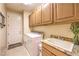 Bright laundry room with cabinets, sink, white washer and dryer, and tile flooring at 2375 Malaga Peak St, Las Vegas, NV 89135