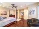 A well-lit main bedroom features dark wood floors and a four poster bed at 2375 Malaga Peak St, Las Vegas, NV 89135