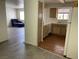 Bright kitchen featuring wood cabinets, laminate countertops, and white appliances, flowing into the living area at 2725 S Nellis Blvd # 1158, Las Vegas, NV 89121