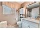 Bathroom featuring a vanity, toilet, storage cabinet, and a framed mirror at 2735 Faiss Dr, Las Vegas, NV 89134