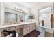 Bathroom vanity area with sink, drawers, large mirror, and a walk-in shower at 2735 Faiss Dr, Las Vegas, NV 89134