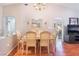 Bright dining room boasts wood floors, a chandelier, a modern table set, and neutral paint at 2735 Faiss Dr, Las Vegas, NV 89134