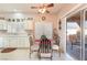 Inviting kitchen and breakfast nook featuring white cabinets, tile floor, and a sliding glass door at 2735 Faiss Dr, Las Vegas, NV 89134