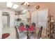 Bright eat-in kitchen with white cabinets, tile floors, and a glass table set under a skylight at 2735 Faiss Dr, Las Vegas, NV 89134