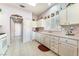 Bright kitchen featuring white cabinets, tile flooring, and natural light at 2735 Faiss Dr, Las Vegas, NV 89134