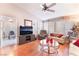 Cozy living room with hardwood floors, a ceiling fan, and views into the connected dining and kitchen at 2735 Faiss Dr, Las Vegas, NV 89134