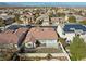 Aerial view of a charming neighborhood home featuring a backyard and lush, green landscaping at 283 Parisian Springs Ct, Las Vegas, NV 89148