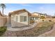 A well-maintained backyard featuring desert landscaping and concrete walkway at 283 Parisian Springs Ct, Las Vegas, NV 89148