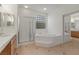 Bathroom featuring double sinks, a shower, and a tub at 283 Parisian Springs Ct, Las Vegas, NV 89148