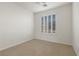 Empty bedroom featuring neutral walls, plush carpet, a ceiling fan, and plantation shutters on the window at 283 Parisian Springs Ct, Las Vegas, NV 89148