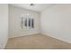 Empty bedroom featuring neutral walls, plush carpet, a ceiling fan, and plantation shutters on the window at 283 Parisian Springs Ct, Las Vegas, NV 89148