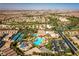 Aerial view of the community pool area with water slides, tennis courts, clubhouse, and surrounding neighborhood at 283 Parisian Springs Ct, Las Vegas, NV 89148