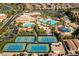 Aerial view of a community pool, tennis courts, lush landscaping and residential properties in the surrounding neighborhood at 283 Parisian Springs Ct, Las Vegas, NV 89148