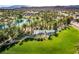 Aerial view of Rhodes Ranch community sign with lush palm trees and a pristine green lawn at 283 Parisian Springs Ct, Las Vegas, NV 89148