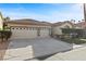 Charming home showcasing a well-manicured lawn, a three-car garage, and a welcoming front entrance at 283 Parisian Springs Ct, Las Vegas, NV 89148