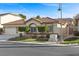 Charming home showcasing a well-manicured lawn, a two-car garage, and beautiful plants at 283 Parisian Springs Ct, Las Vegas, NV 89148