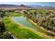 Aerial shot of the golf course with trees and a large lake at 283 Parisian Springs Ct, Las Vegas, NV 89148