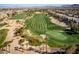 Aerial view of a lush green golf course, sand traps, and manicured landscaping at 283 Parisian Springs Ct, Las Vegas, NV 89148