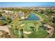 Aerial view of a beautiful golf course featuring lush greenery, a lake, and mature trees at 283 Parisian Springs Ct, Las Vegas, NV 89148