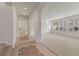 Bright living room with tile flooring, large windows, and modern lighting at 283 Parisian Springs Ct, Las Vegas, NV 89148