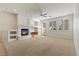 Spacious living room featuring a fireplace, neutral carpet, and abundant natural light at 283 Parisian Springs Ct, Las Vegas, NV 89148