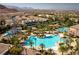 Expansive lagoon-style pool with palm trees, a water playground, and mountain views at 283 Parisian Springs Ct, Las Vegas, NV 89148