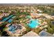 Aerial view of a stunning community pool, water slides, tennis courts, and manicured landscaping at 283 Parisian Springs Ct, Las Vegas, NV 89148