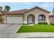 Charming single-story home with a well-manicured lawn, arched entryway, and a two-car garage at 3021 Scenic Valley Way, Henderson, NV 89052