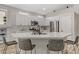 Bright kitchen featuring white cabinetry, a large kitchen island with seating, and modern appliances at 3021 Scenic Valley Way, Henderson, NV 89052