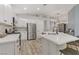 Modern kitchen featuring stainless steel appliances, white cabinets, and a large center island with a marble countertop at 3021 Scenic Valley Way, Henderson, NV 89052