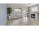 Bright living room with hardwood floors, fireplace, sliding glass doors leading to the backyard at 3021 Scenic Valley Way, Henderson, NV 89052