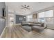 Bright living room featuring modern furnishings, a ceiling fan, and an open floor plan at 3021 Scenic Valley Way, Henderson, NV 89052