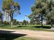 Community green space with large shade trees and a view of the Stratosphere at 3157 Pinehurst Dr # B, Las Vegas, NV 89109