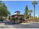 Charming stone guard house at the entrance of a secure community with lush landscaping at 3157 Pinehurst Dr # B, Las Vegas, NV 89109