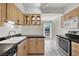 Traditional kitchen with light wood cabinets, black countertops, white tile floors, and stainless steel appliances at 3157 Pinehurst Dr # B, Las Vegas, NV 89109