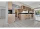 Inviting kitchen featuring tile floors, updated appliances, generous cabinet space, and excellent lighting at 3157 Pinehurst Dr # B, Las Vegas, NV 89109