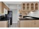 Functional kitchen design with black appliances, light cabinetry, and modern backsplash for a fresh, clean aesthetic at 3157 Pinehurst Dr # B, Las Vegas, NV 89109