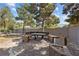 Outdoor dining area with built-in seating, wooden deck, mature trees, and privacy wall, ideal for entertaining at 3585 Tobias Ln, Las Vegas, NV 89120