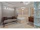 Luxurious bathroom featuring a soaking tub, mosaic tile accents, and elegant vanity with designer fixtures at 3585 Tobias Ln, Las Vegas, NV 89120