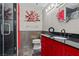 Modern bathroom with a black shower, unique decor, and a stylish red vanity at 3585 Tobias Ln, Las Vegas, NV 89120