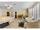 Spacious carpeted bedroom featuring plantation shutters and a comfortable seating area at 3585 Tobias Ln, Las Vegas, NV 89120