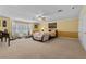 Inviting bedroom with carpeting, plantation shutters and a cozy seating area near the bed at 3585 Tobias Ln, Las Vegas, NV 89120