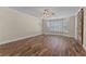 Bright bedroom with wood-look tile floors, a ceiling fan, and large windows with plantation shutters at 3585 Tobias Ln, Las Vegas, NV 89120