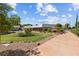 Lush landscaping, long driveway, and sprawling lawn, creating a serene and inviting outdoor space at 3585 Tobias Ln, Las Vegas, NV 89120