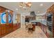 Spacious kitchen features dark wood cabinets, modern appliances, large center island, and stylish tile flooring at 3585 Tobias Ln, Las Vegas, NV 89120