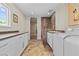 Bright laundry room with white cabinets, sleek countertops, and a convenient washing station at 3585 Tobias Ln, Las Vegas, NV 89120