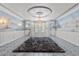 Bright living room showcasing shuttered windows, decorative walls, statement chandelier, and tile floor at 3585 Tobias Ln, Las Vegas, NV 89120