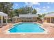 Large outdoor pool with brick surround, surrounded by mature trees, perfect for relaxing and entertaining at 3585 Tobias Ln, Las Vegas, NV 89120